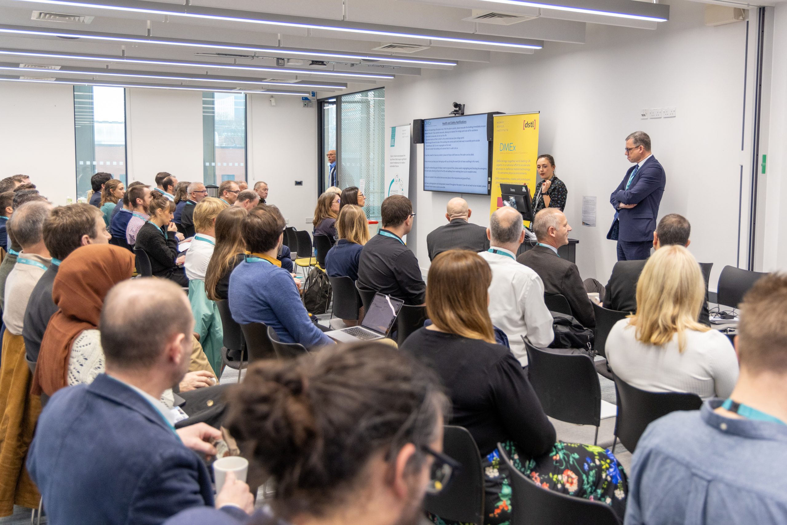 Event attendees watching a seminar in the Royce Hub Building meeting rooms